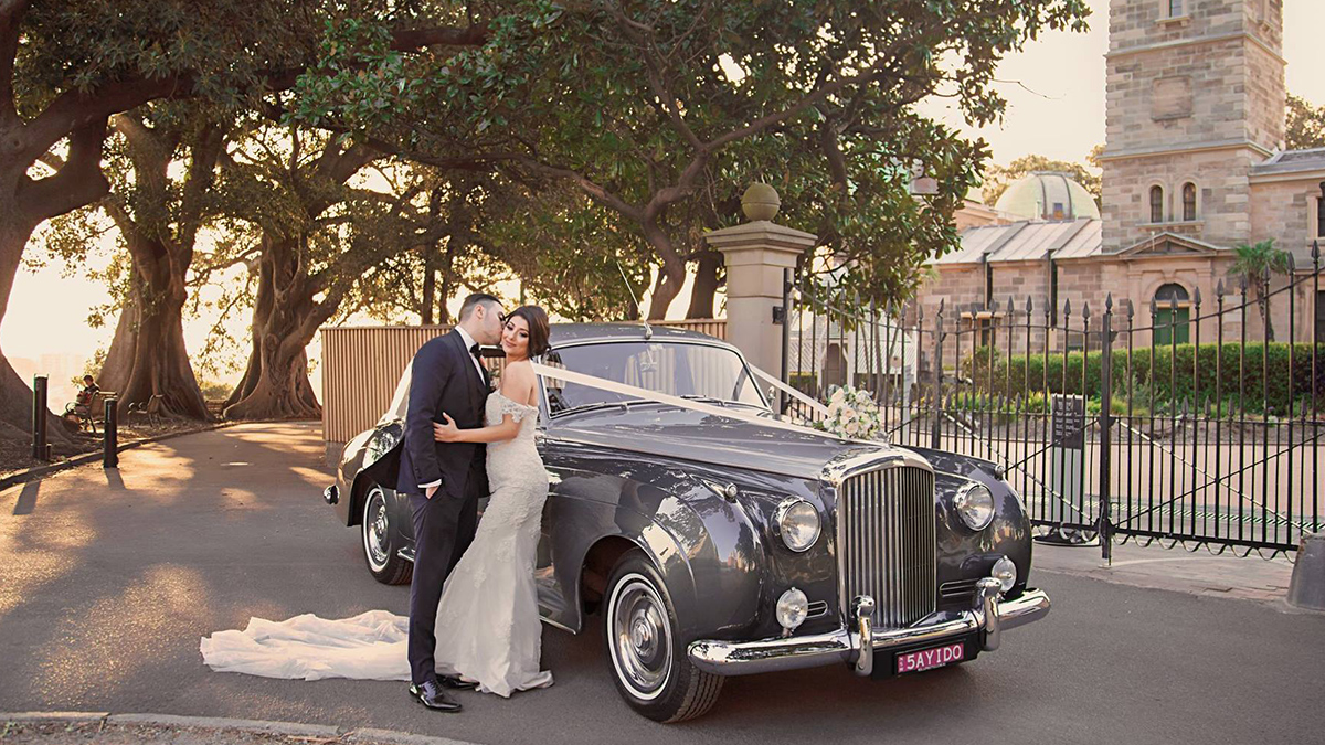 just married couple with their rolls royce classic wedding car in sydney